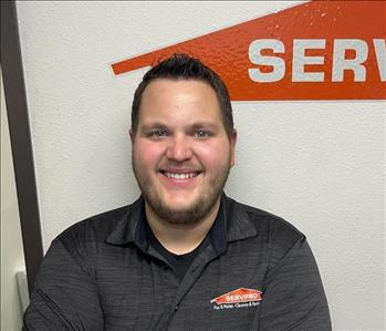 Male employee standing in front of Servpro sign
