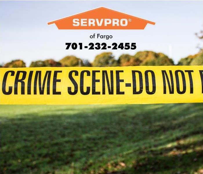 Yellow crime scene tape delineates an active crime scene investigation.