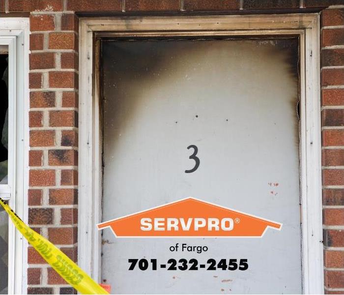 The door to Apartment 3 shown with yellow “do not cross” tape blocking the entrance to the fire-damaged unit.